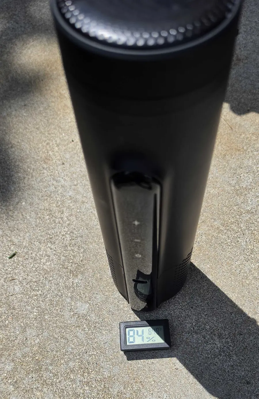 My black Svalto Cooler Pro running outdoors in direct sun during the informal two-hour check, with the outdoor meter beside it.